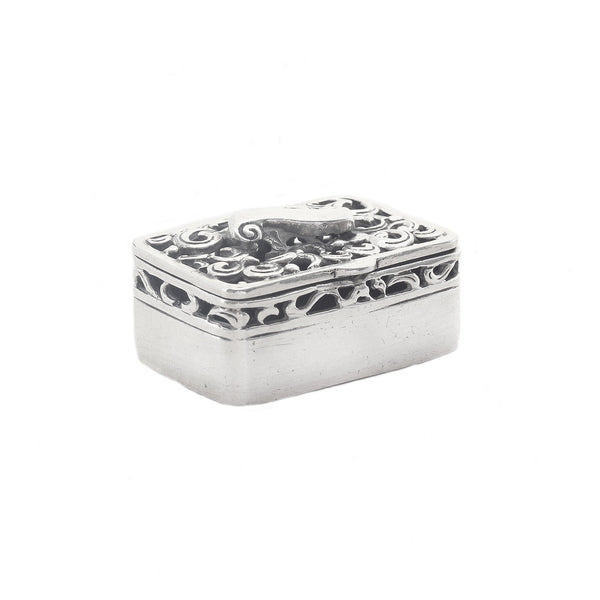 Silver decorative box with intricate patterns on a white background