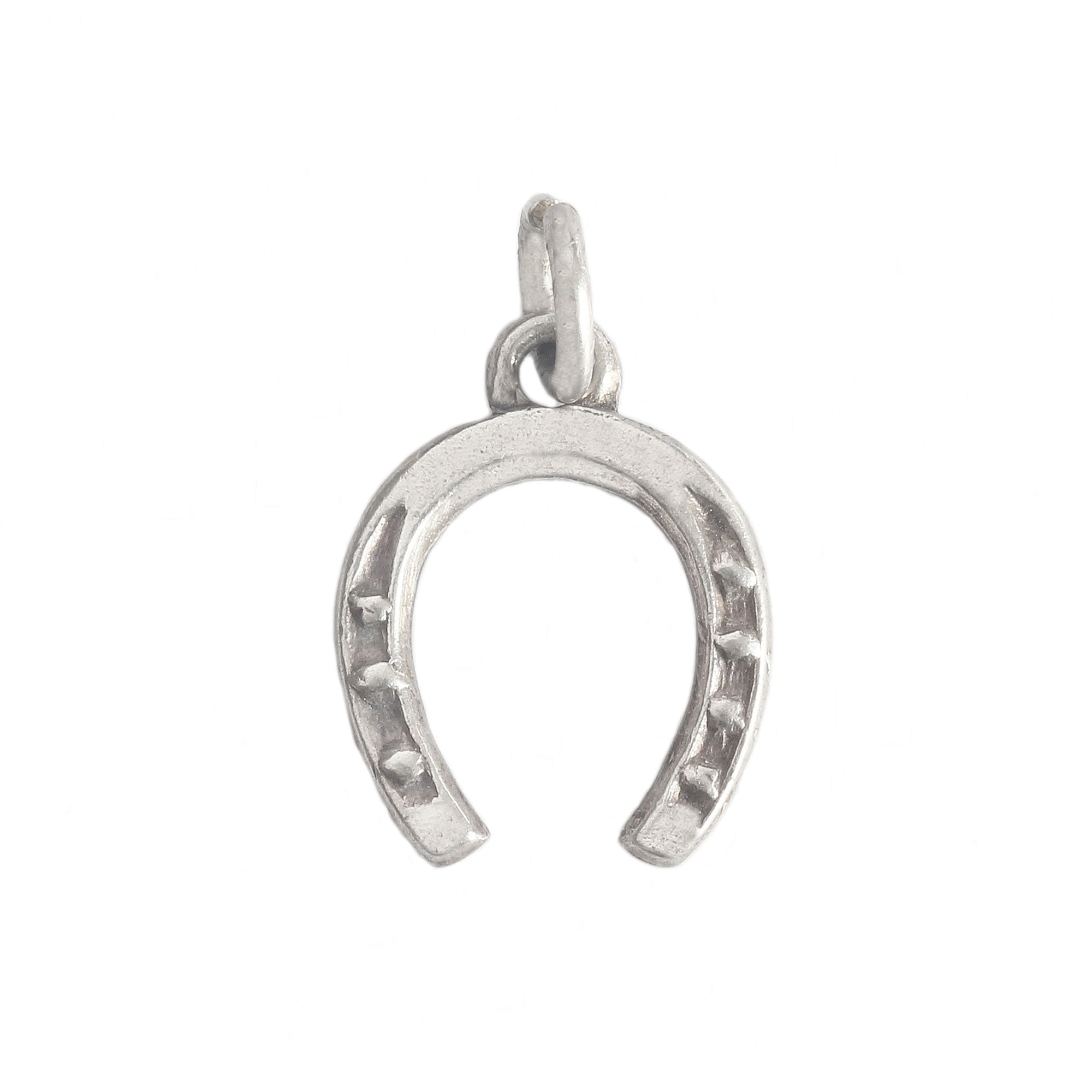 horseshoe charm in silver on white background