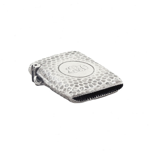 Silver matches case with textured surface and circular emblem on a white background