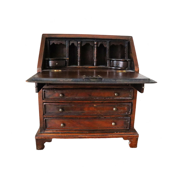 antique wooden  bureau with a hinged top on a white background
