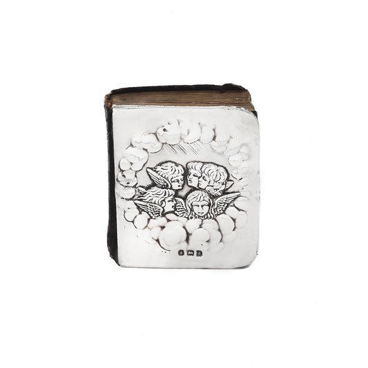 Decorative book with angel designs on a white background