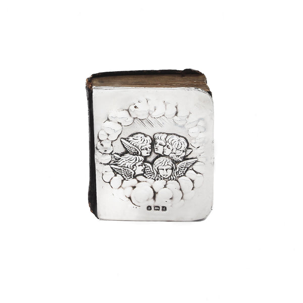 Decorative book with angel designs on a white background