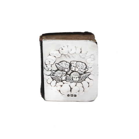 Decorative book with angel designs on a white background