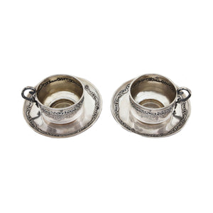 French miniature cup and saucer set with floral detailing