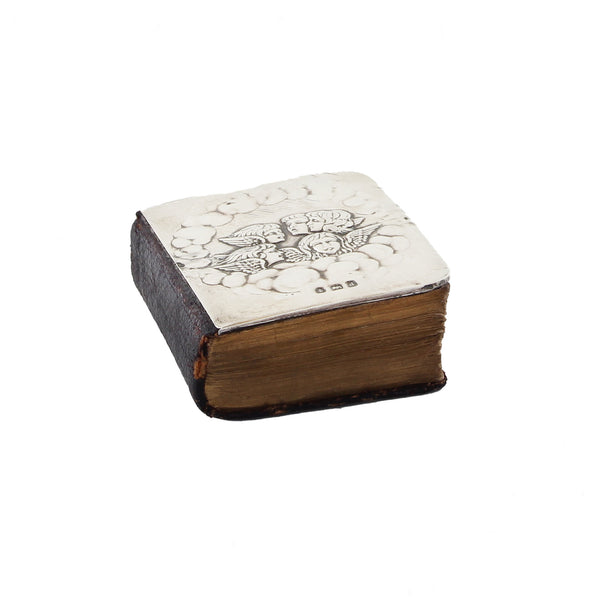 Decorative book with a white cover featuring black floral designs on a white background