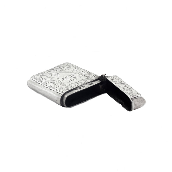 Silver vesta case with floral engraving on a white background