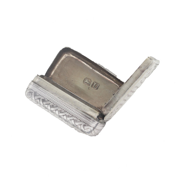 Silver vinaigrette opened up showing hallmark on a white background
