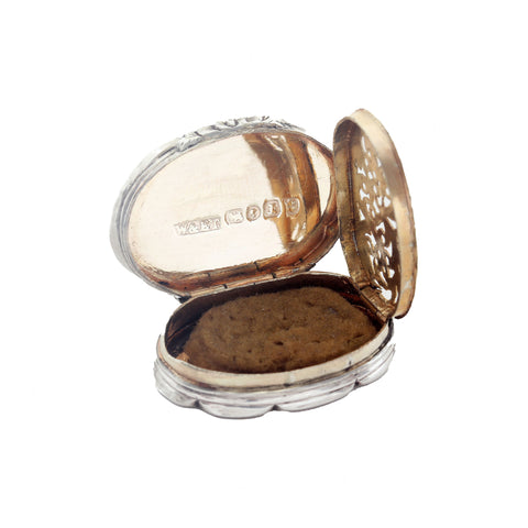 Open silver vinaigrette with engraved details on a white background