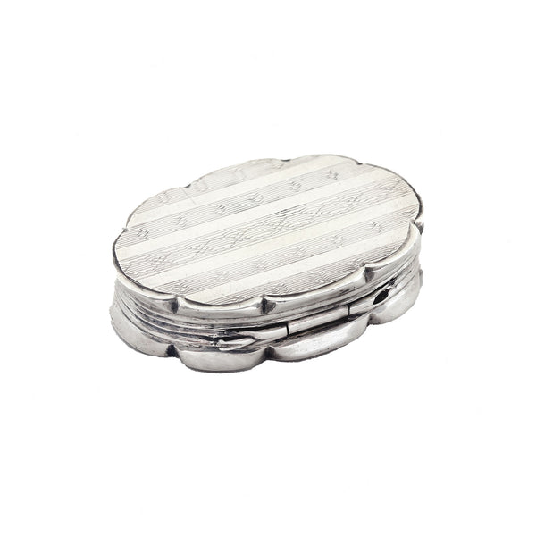 Silver engine turned oval vinaigrette on a white background