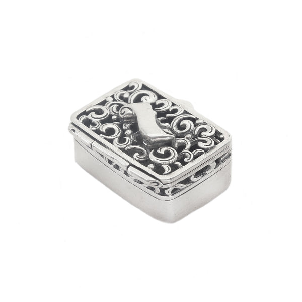 Decorative silver box with intricate patterns on a white background