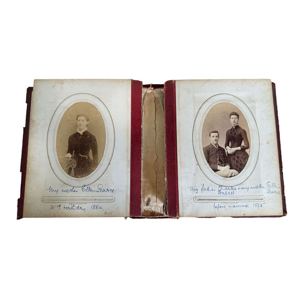 Open photo album with vintage portraits on a white background