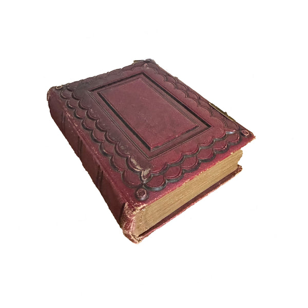antique red leather-bound book on a white background