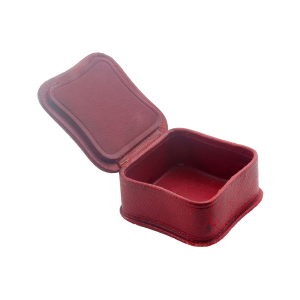 Red stamp box with open lid on a white background