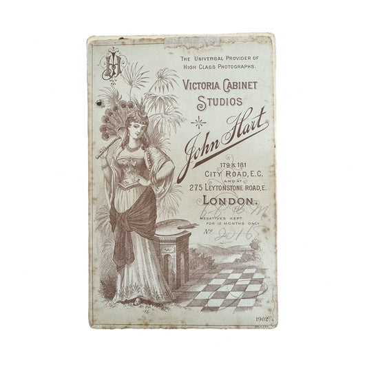 Vintage-style advertisement card for Victoria Cabinet Studios with a woman holding a fan on a white background.