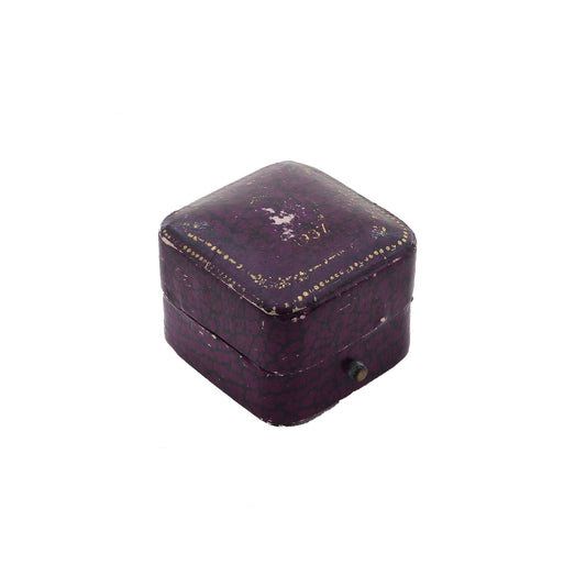Small purple jewelry box with gold accents on a white background