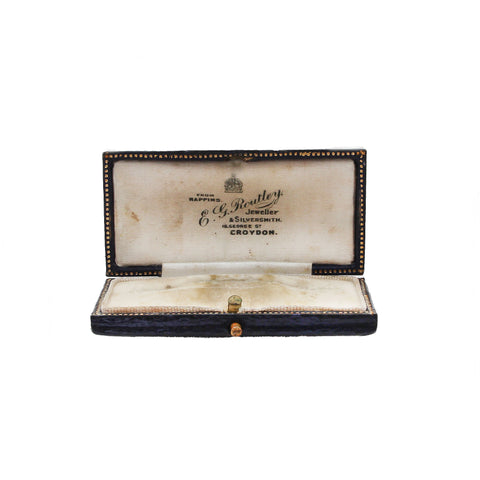 Vintage jewelry box with 'C. G. routley' branding on a white background