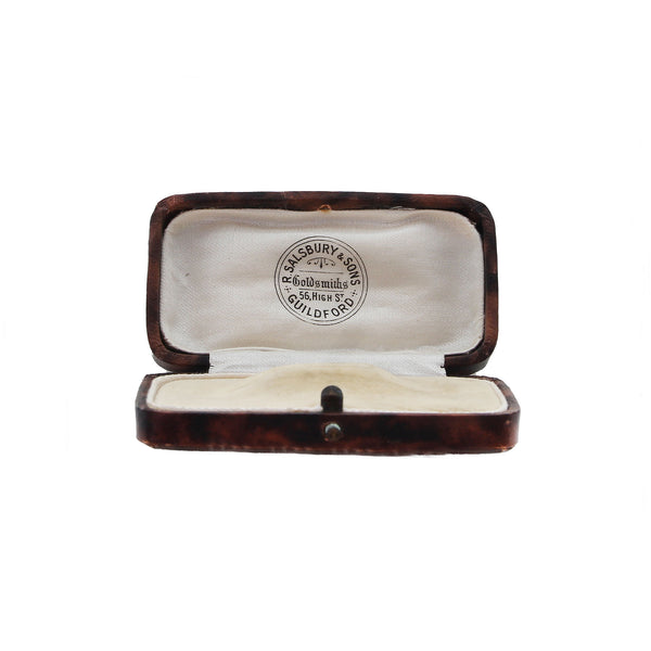 Open jewelry box with a visible brand logo on a white background