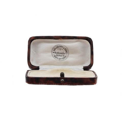 Open jewelry box with a visible brand logo on a white background