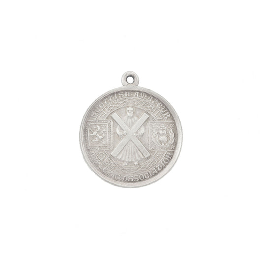 Silver pendant with intricate design on a white background