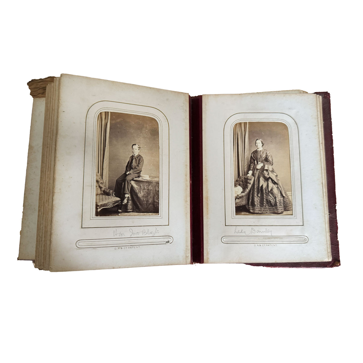Open photo album with vintage portraits on a white background