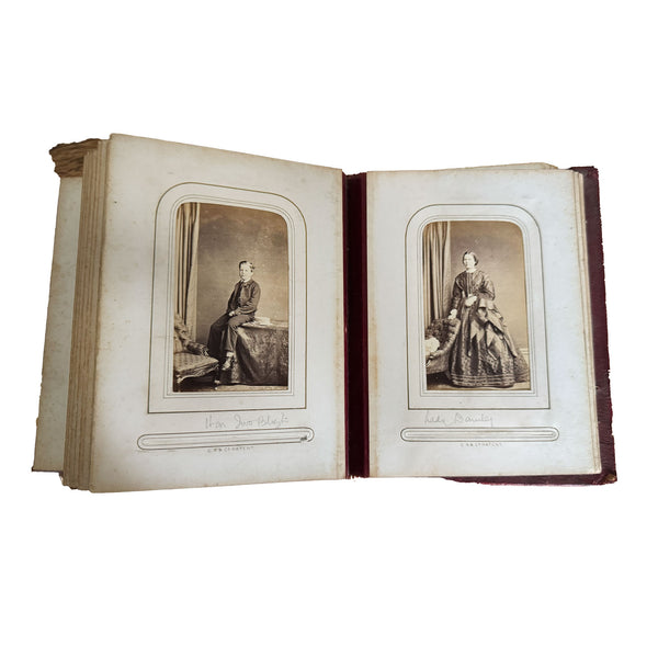 Open photo album with vintage portraits on a white background