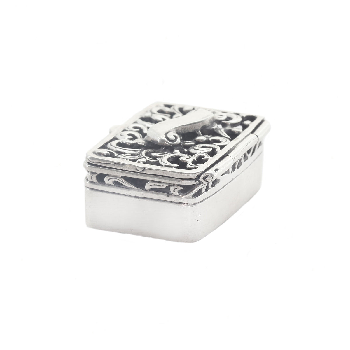 Silver decorative box with intricate patterns on a white background