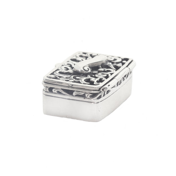 Silver decorative box with intricate patterns on a white background