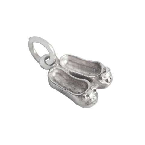 Silver shoe charm on a white background