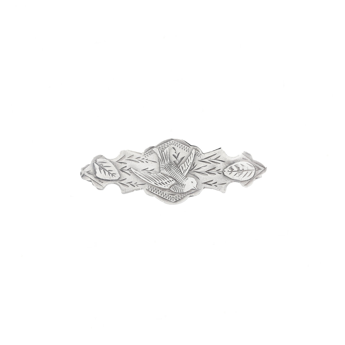 Silver brooch with leaf design on a white background