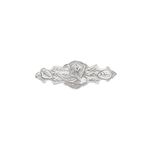 Silver brooch with leaf design on a white background
