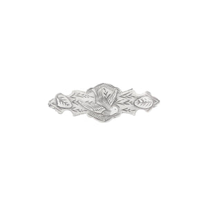 Silver brooch with leaf design on a white background