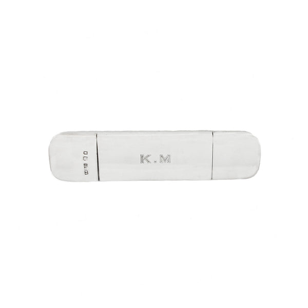 White curved silver case with 'K.M' branding on a white background
