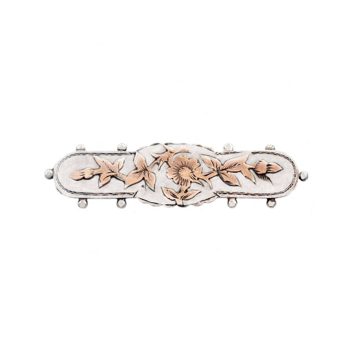 Decorative brooch with floral designs on a white background