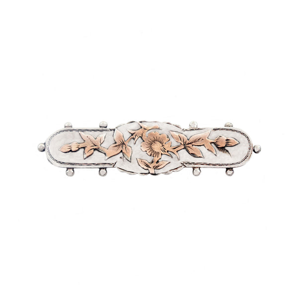 Decorative brooch with floral designs on a white background