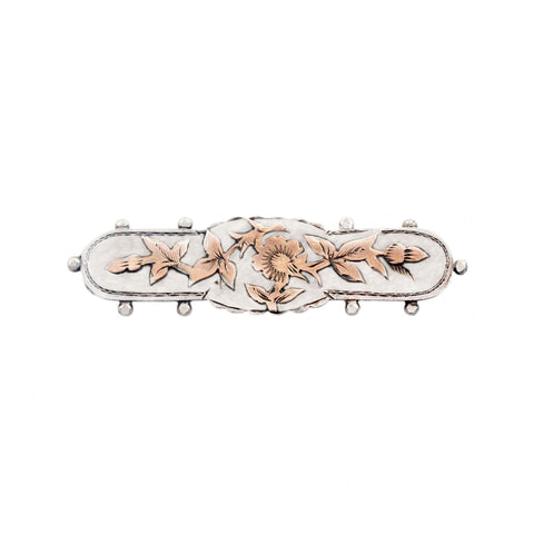 Decorative brooch with floral designs on a white background