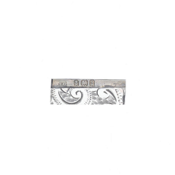 Decorative metal strip with intricate patterns on a white background