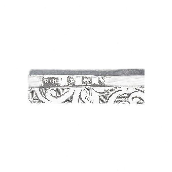 Decorative hallmark with intricate patterns and engraved designs on a white background