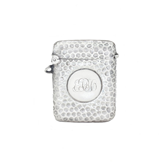 Silver textured vesta with monogram on a white background