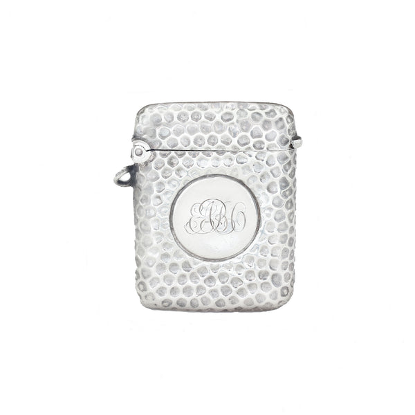 Silver textured vesta with monogram on a white background