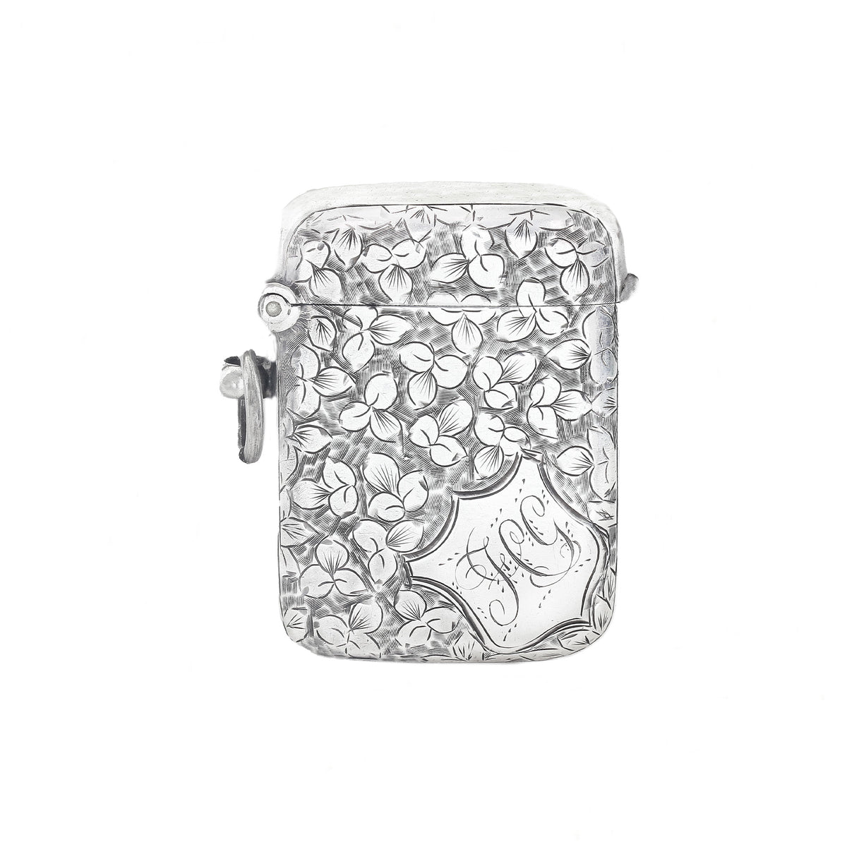Silver vesta with floral design and 'J' engraving on a white background