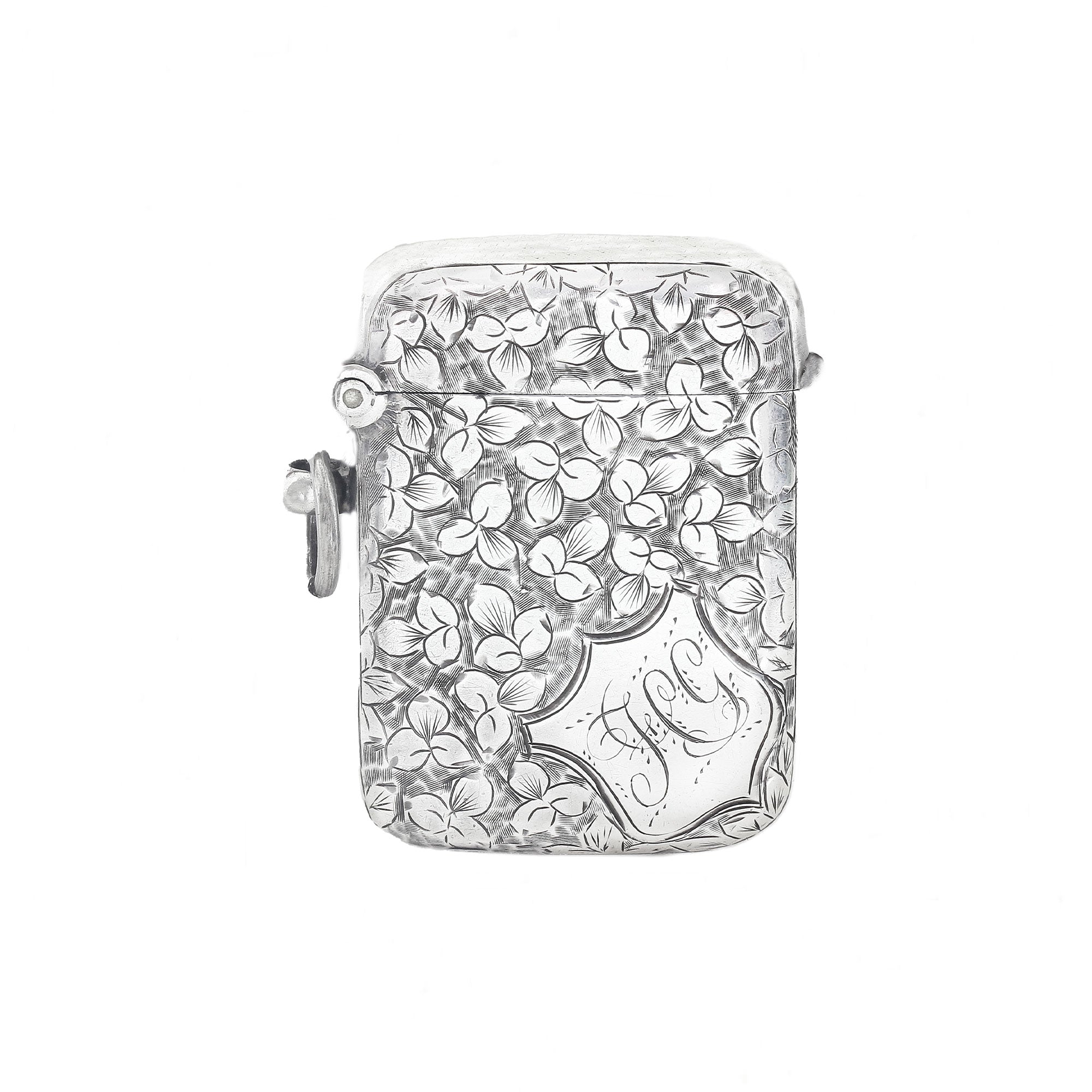 Silver vesta with floral design and 'J' engraving on a white background
