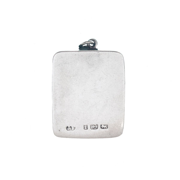 Silver pendant with engraved hallmark on a white background