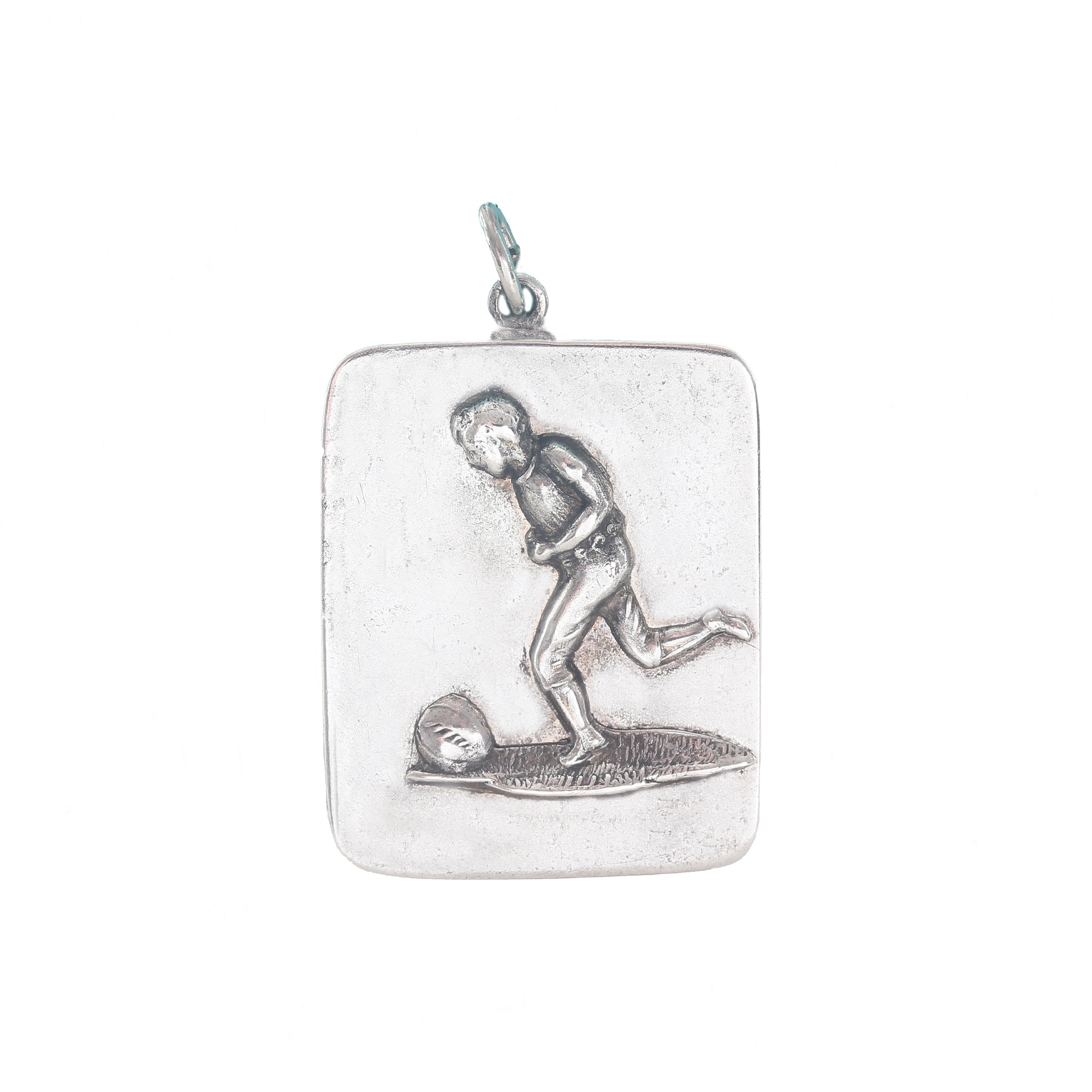 Silver pendant with a footballer design on a white background