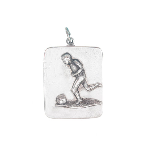 Silver pendant with a footballer design on a white background