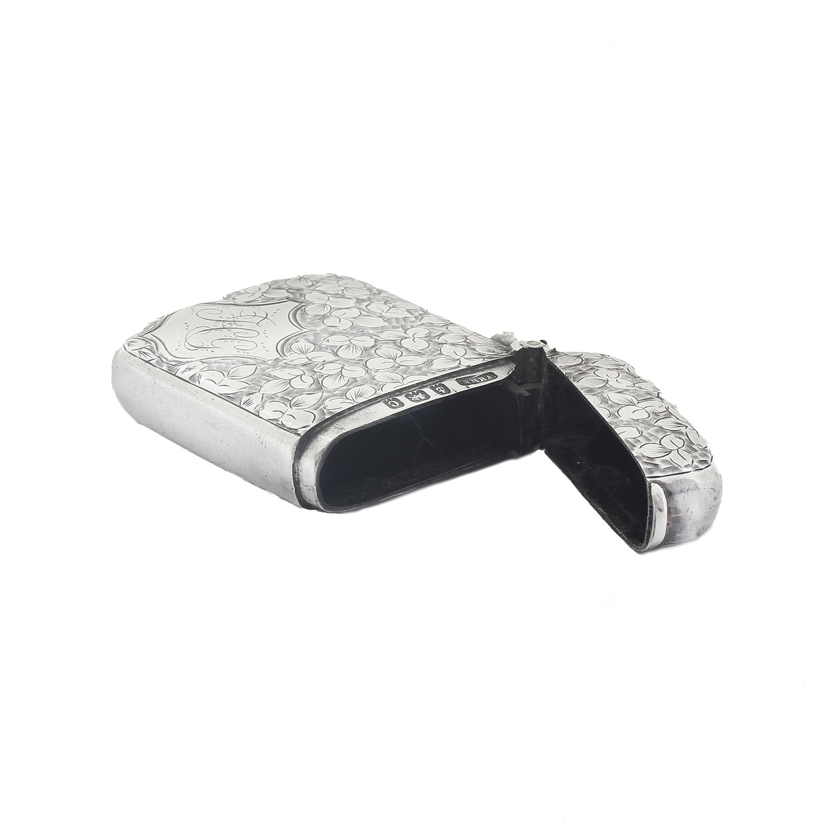 Silver match case with intricate design on a white background