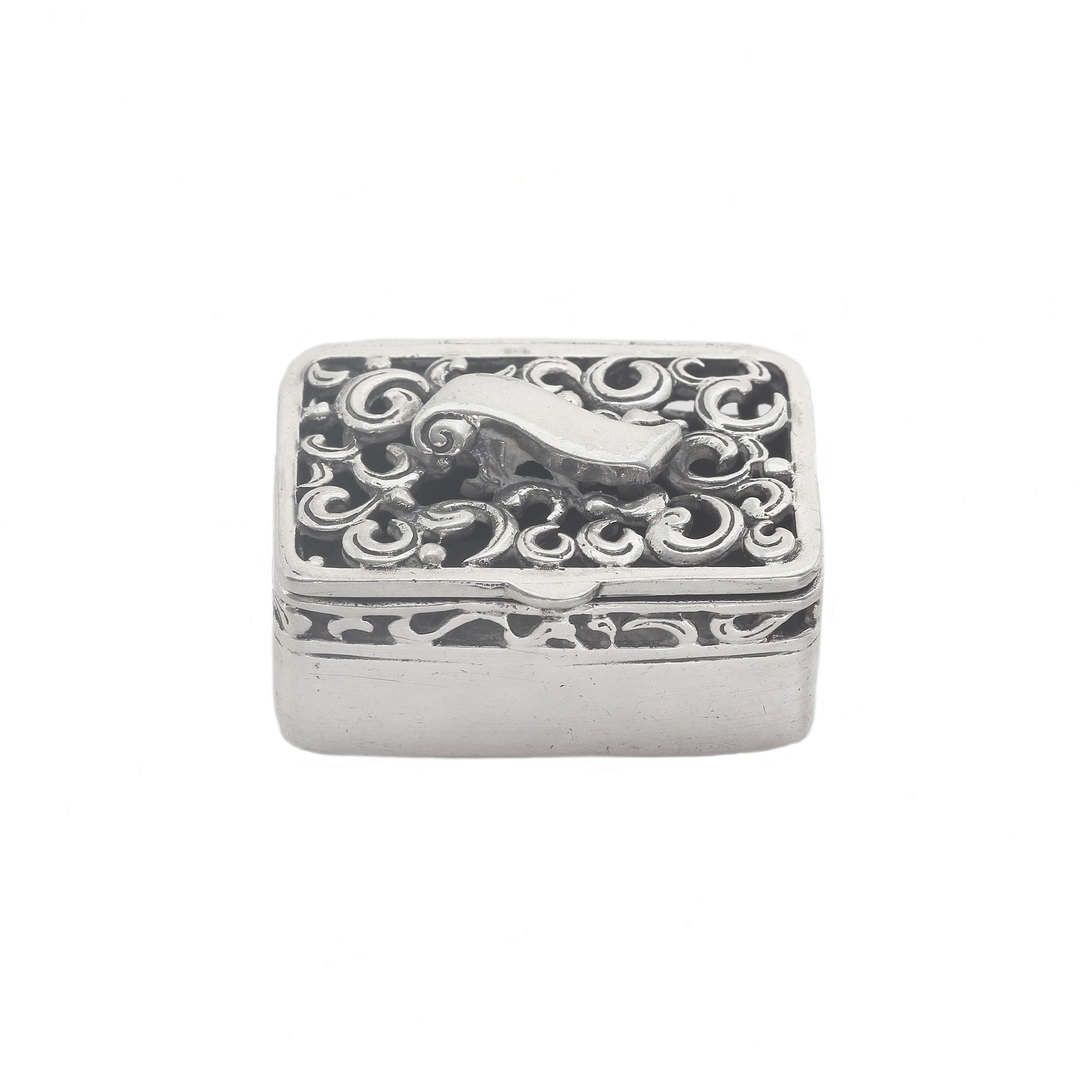 Decorative silver box with intricate patterns on a white background