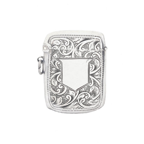 Silver vesta case case with intricate floral patterns on a white background