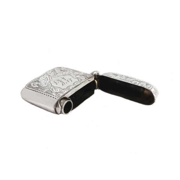 Silver vesta with intricate designs on a white background