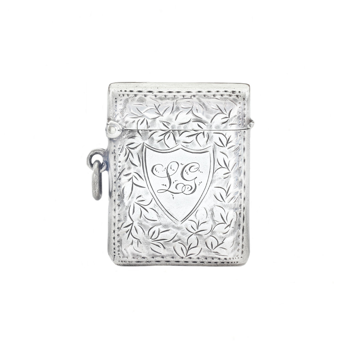 Silver decorative vesta with intricate designs on a white background