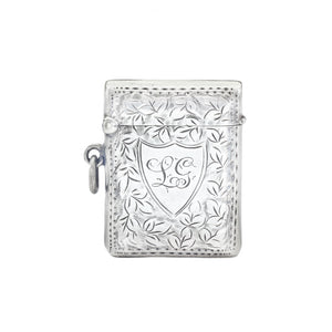 Silver decorative vesta with intricate designs on a white background